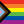 The image shows the Progress Pride Flag, featuring horizontal stripes of red, orange, yellow, green, blue, and purple, with a chevron of black, brown, light blue, pink, and white stripes on the left side.